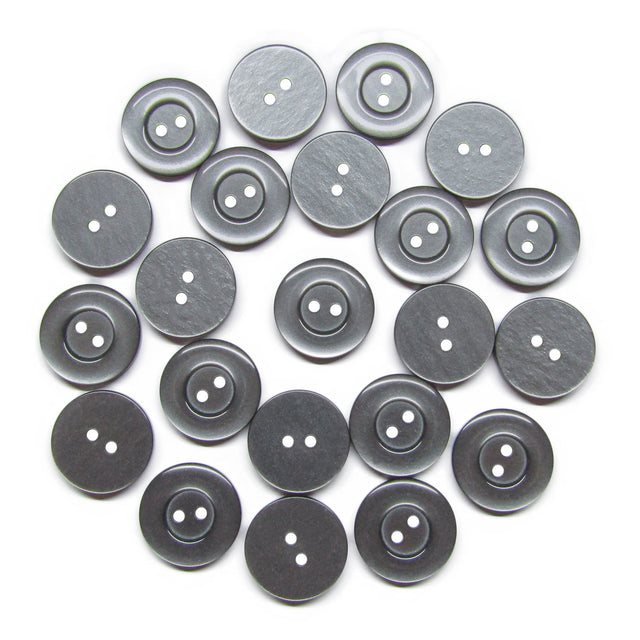 Twenty-five Commercial Food Service Buttons, round and gray with two holes, are arranged in a loose circular pattern on a white background.