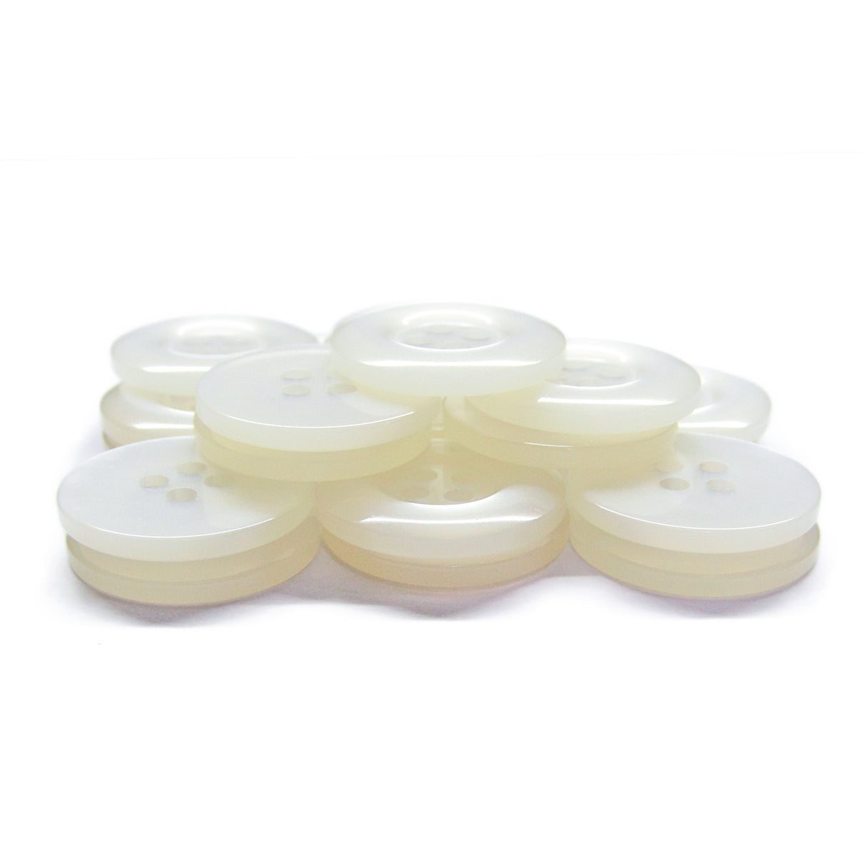 A stack of Commercial Food Service Buttons—translucent white, four-hole plastic—on a white surface, ideal for use as plain or work uniform buttons.