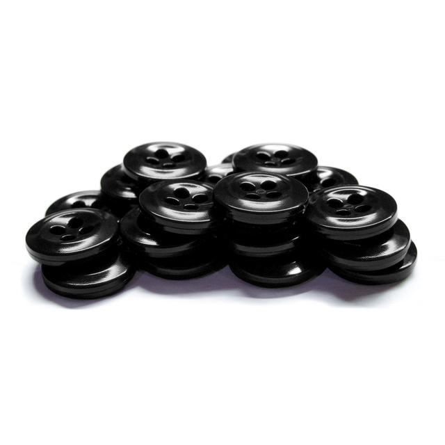 A stack of black, four-hole Work Shirt Buttons made of plastic is arranged on a white background.