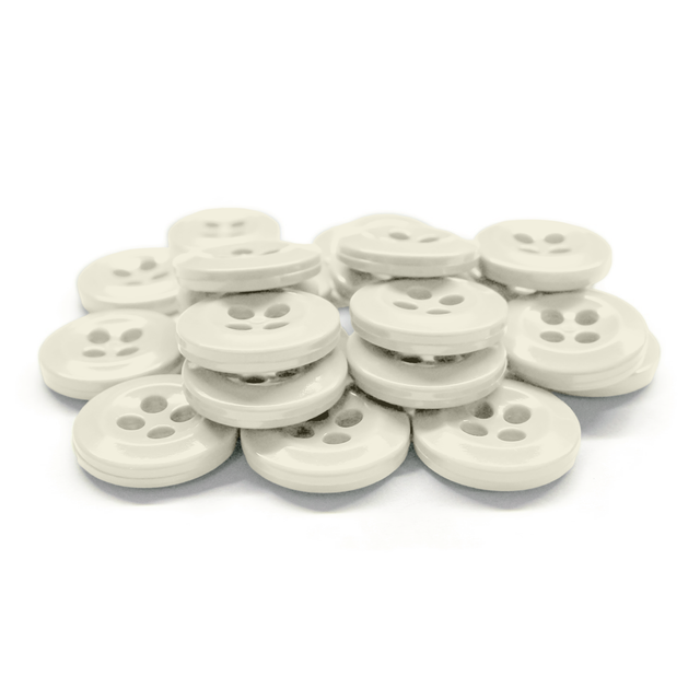 A stack of white Work Shirt Buttons with four holes arranged on a white background.