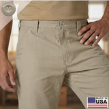 A man wearing tan Work Pants Buttons and a beige shirt stands with his hand on his hip, with a Made in USA label in the corner. The pants feature a military-grade button set for enhanced durability and everyday reliability.