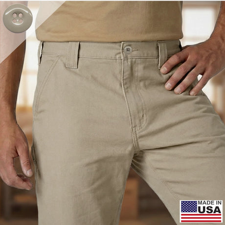 A man wearing tan Work Pants Buttons and a beige shirt stands with his hand on his hip, with a Made in USA label in the corner. The pants feature a military-grade button set for enhanced durability and everyday reliability.