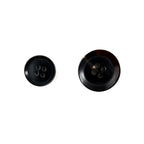Two Buffalo Horn Suit Buttons in black of varying sizes rest on a white background, ideal for adding a touch of luxury to coats or sophistication to suits.