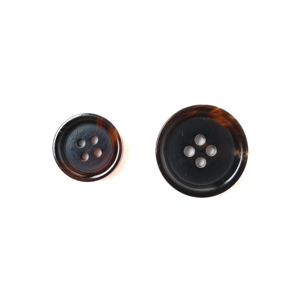 Two round Buffalo Horn Suit Buttons in different sizes, each with four holes, ideal for luxury coats or suits, displayed on a white background.