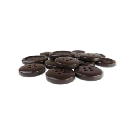 A pile of Basic Suit Buttons, round and dark brown with four holes, made of poly-nylon, rests on a white background.