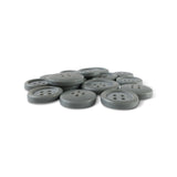A pile of Basic Suit Buttons, gray with four holes and made from poly-nylon, arranged on a white background.