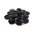 Buffalo Horn Suit Buttons in black with four holes are arranged on a white background—ideal as luxury buttons for coats or elegant suit fastenings.