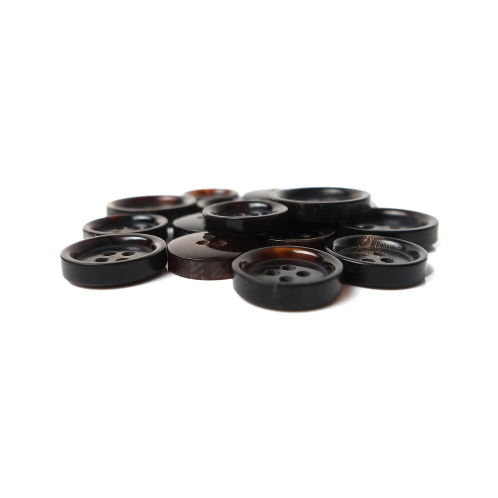 A set of Buffalo Horn Suit Buttons, round and dark-colored with four holes, is displayed on a white background.