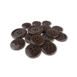 A pile of Basic Suit Buttons, dark brown, round, and featuring four holes, rests on a white background.