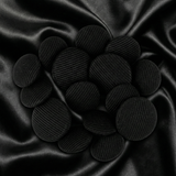 Tuxedo Suit Buttons are displayed in a cluster on smooth, crumpled black satin fabric.