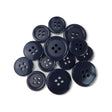 A selection of Basic Suit Buttons in dark blue poly-nylon, each with four holes and in assorted sizes, is displayed on a white background.