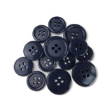 A selection of Basic Suit Buttons in dark blue poly-nylon, each with four holes and in assorted sizes, is displayed on a white background.