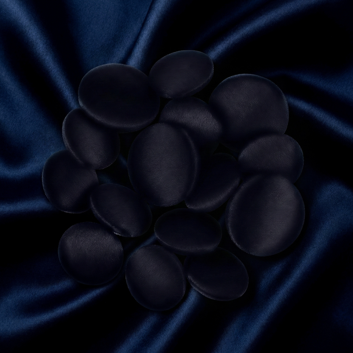Tuxedo Suit Buttons are smooth and black, styled to resemble polished stones on dark blue satin, evoking the refined elegance of a tuxedo with a soft, striking texture contrast.