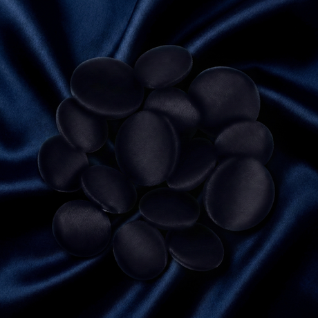 Tuxedo Suit Buttons are smooth and black, styled to resemble polished stones on dark blue satin, evoking the refined elegance of a tuxedo with a soft, striking texture contrast.