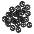 A pile of black Trouser Fly Pant Buttons with four holes scattered on a white background.