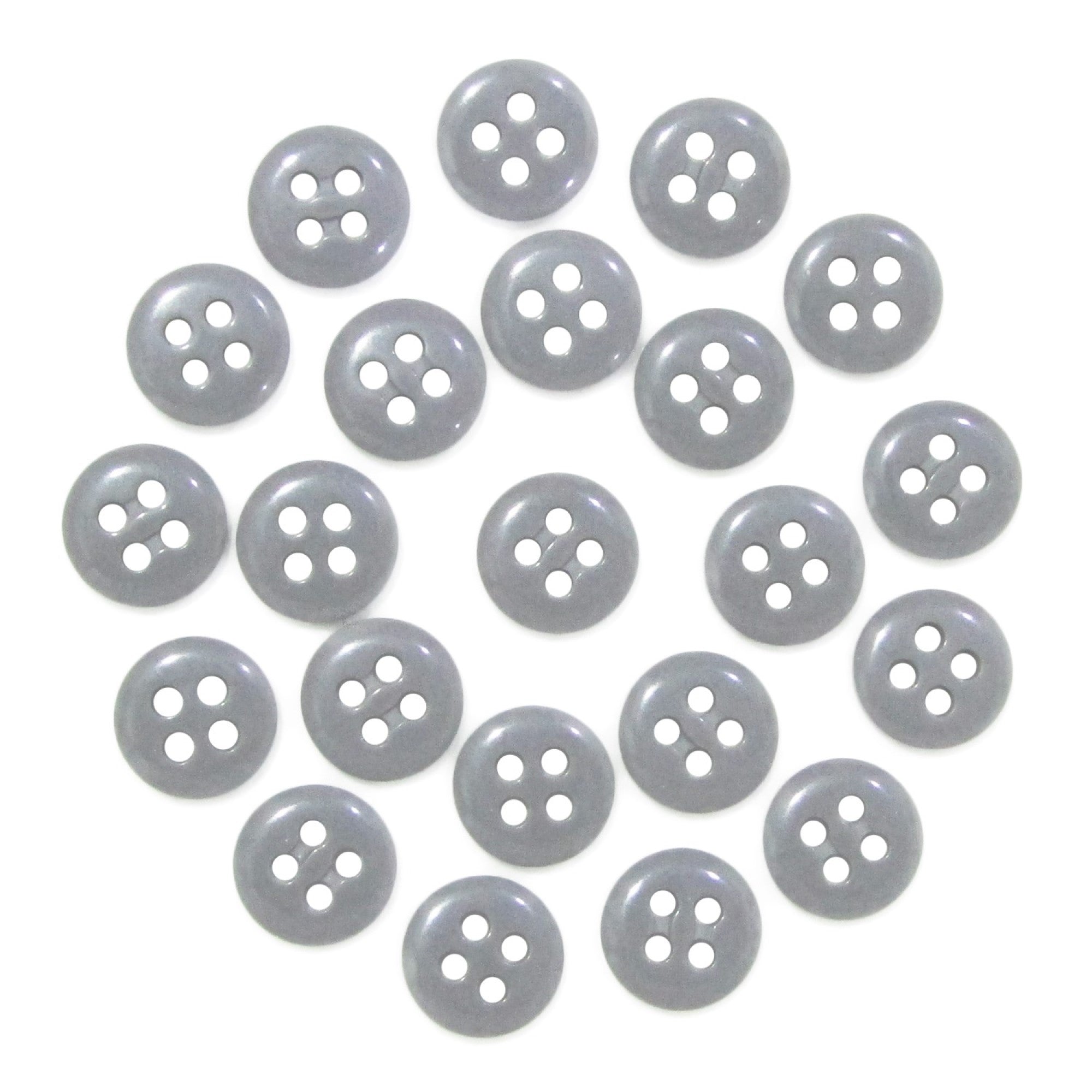 Twenty-four Trouser Fly Pant Buttons, gray with four holes, are arranged in an S shape on a white background.