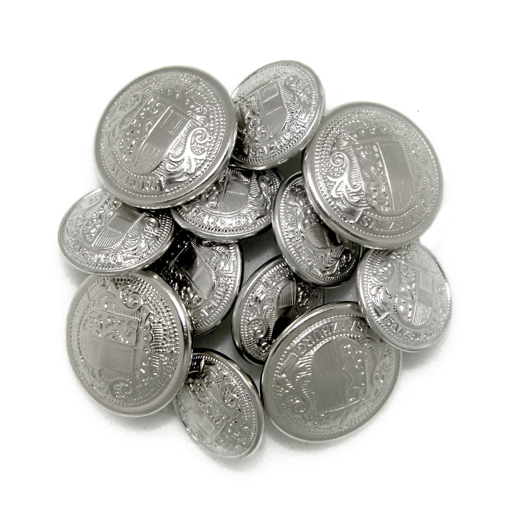 A pile of shiny, silver Salzburg Crest Design Metal Blazer Buttons with ornate engraved shields and decorative patterns—ideal as stylish replacements or for adding elegance to any blazer.