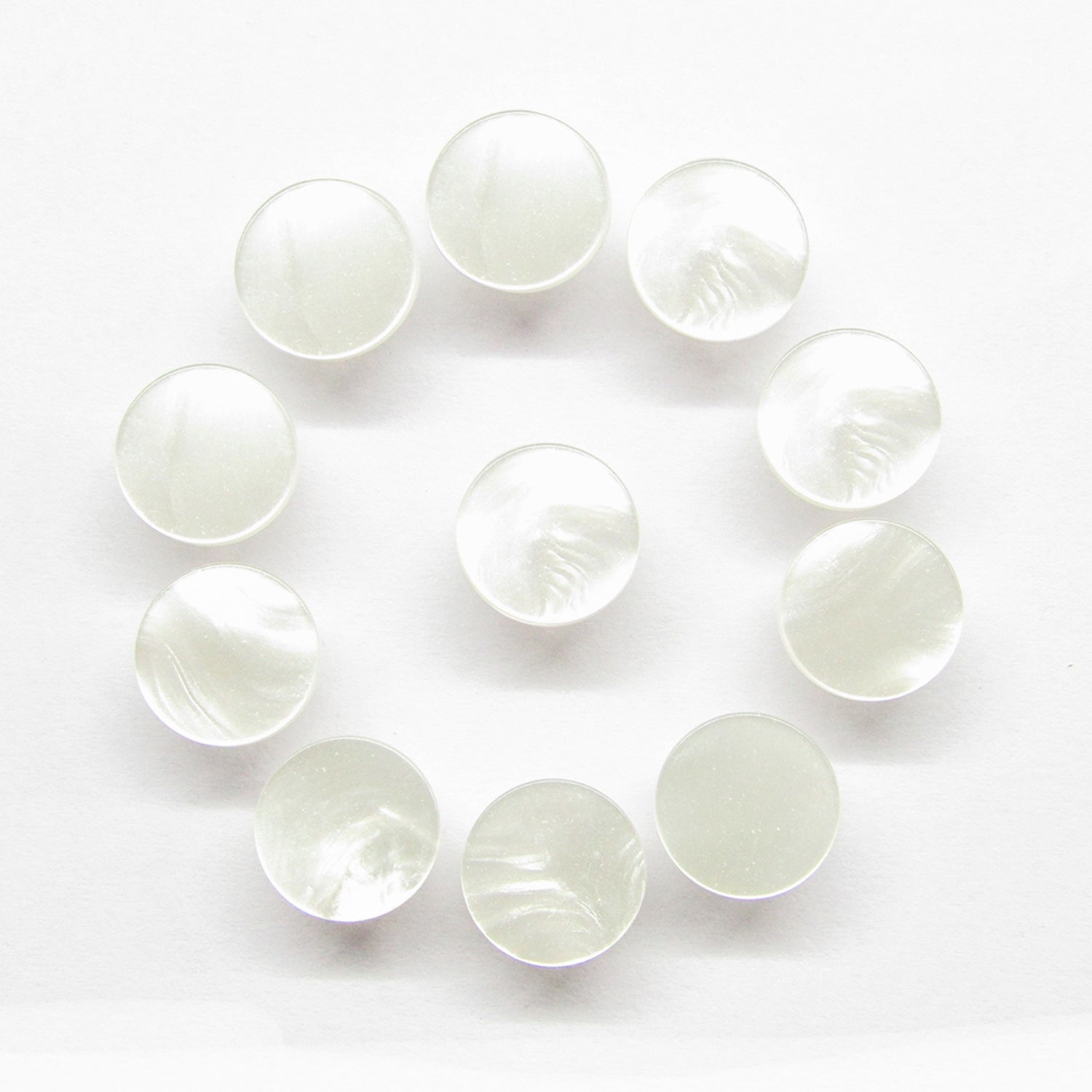 Twelve Flat Bridal Trim and Bustle Buttons with a glossy finish are arranged in a circle on a white background.