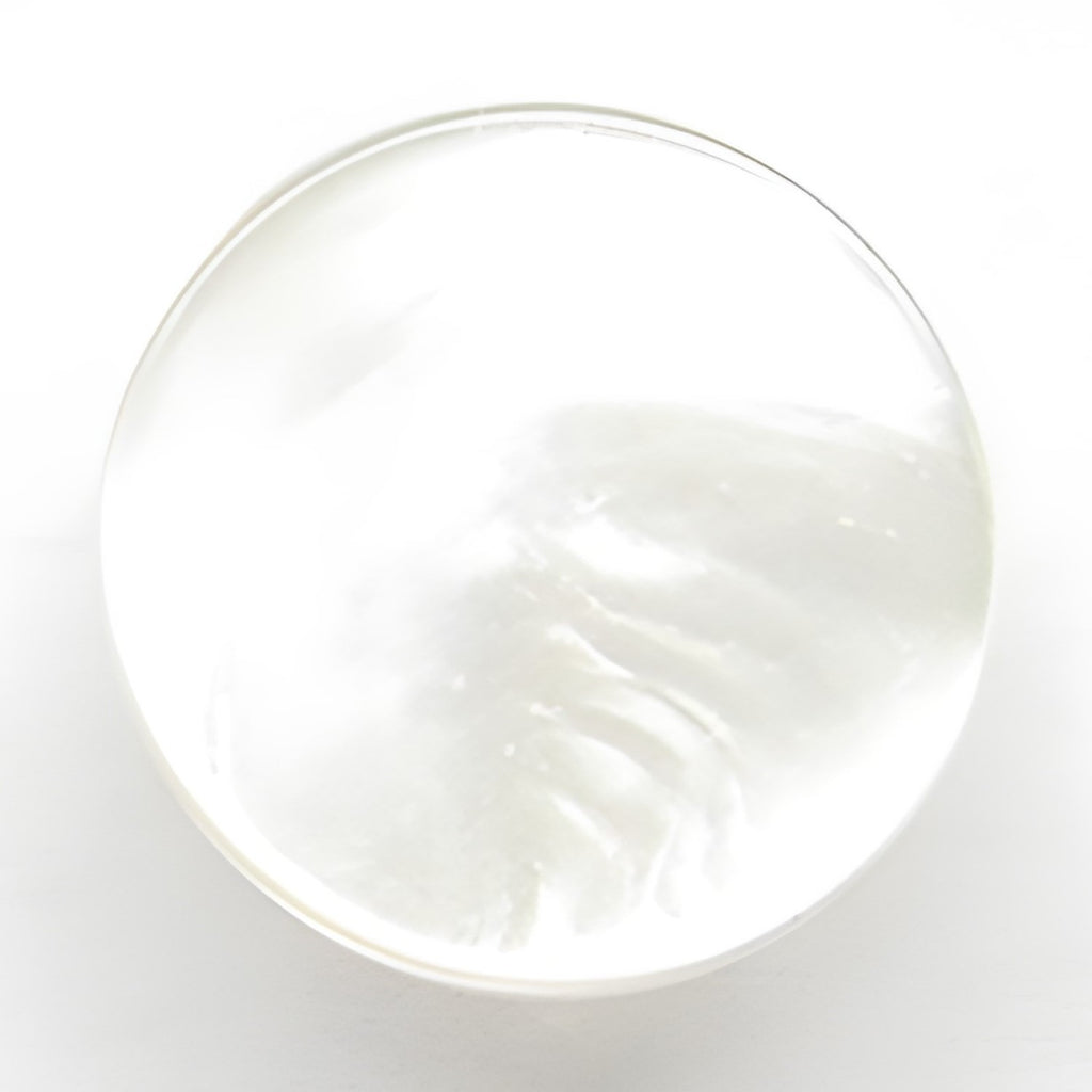 A translucent, round bar of clear soap on a white background, inspired by Flat Bridal Trim and Bustle Buttons.