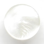 A translucent, round bar of clear soap on a white background, inspired by Flat Bridal Trim and Bustle Buttons.