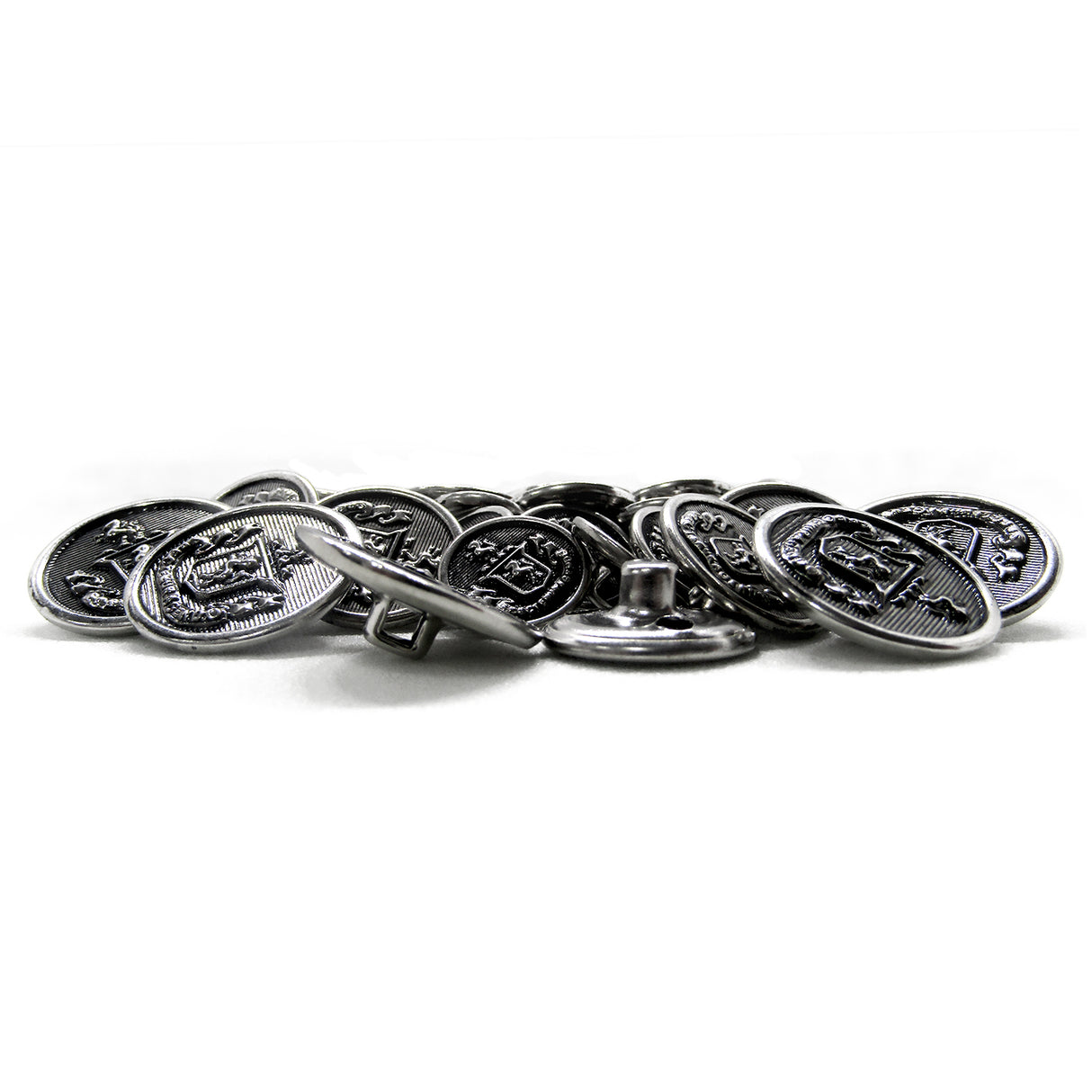 Lion Crest Design Metal Blazer Buttons, featuring embossed silver designs, are shown scattered on a white surface.