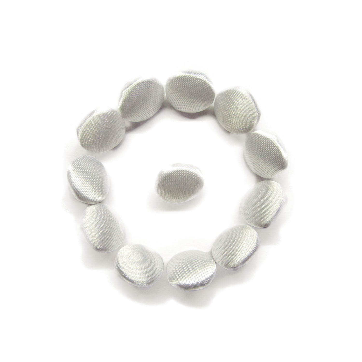 Twelve Silk Satin Bridal Buttons, small, white, and round, are arranged in a circle with one in the center on a white background.