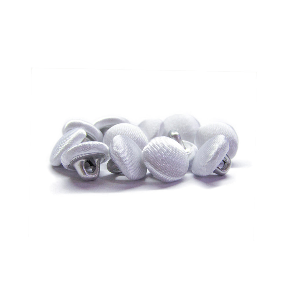 A pile of Silk Satin Bridal Buttons with metal shanks rests on a white background—ideal as delicate trim for wedding dresses.