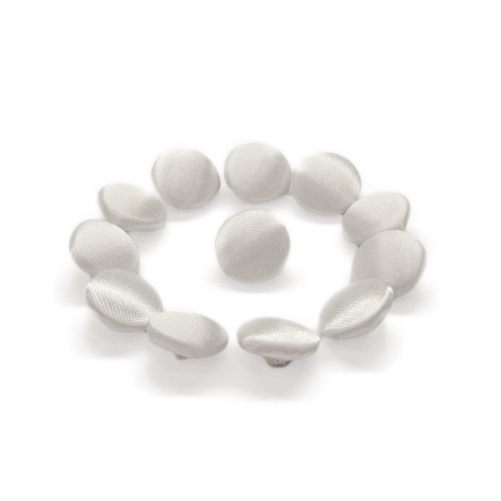 Twelve Silk Satin Bridal Buttons, round and silver, are arranged in a circle on a white background.