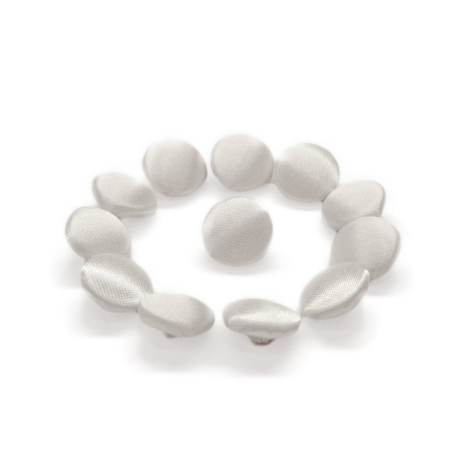 Twelve Silk Satin Bridal Buttons, round and silver, are arranged in a circle on a white background.