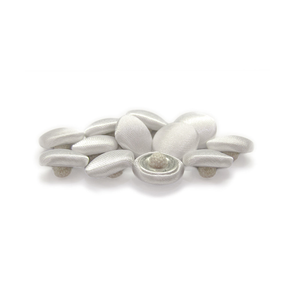 Silk Satin Bridal Buttons, featuring small oval shapes, are elegantly clustered on a white background.