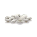 Silk Satin Bridal Buttons, featuring small oval shapes, are elegantly clustered on a white background.