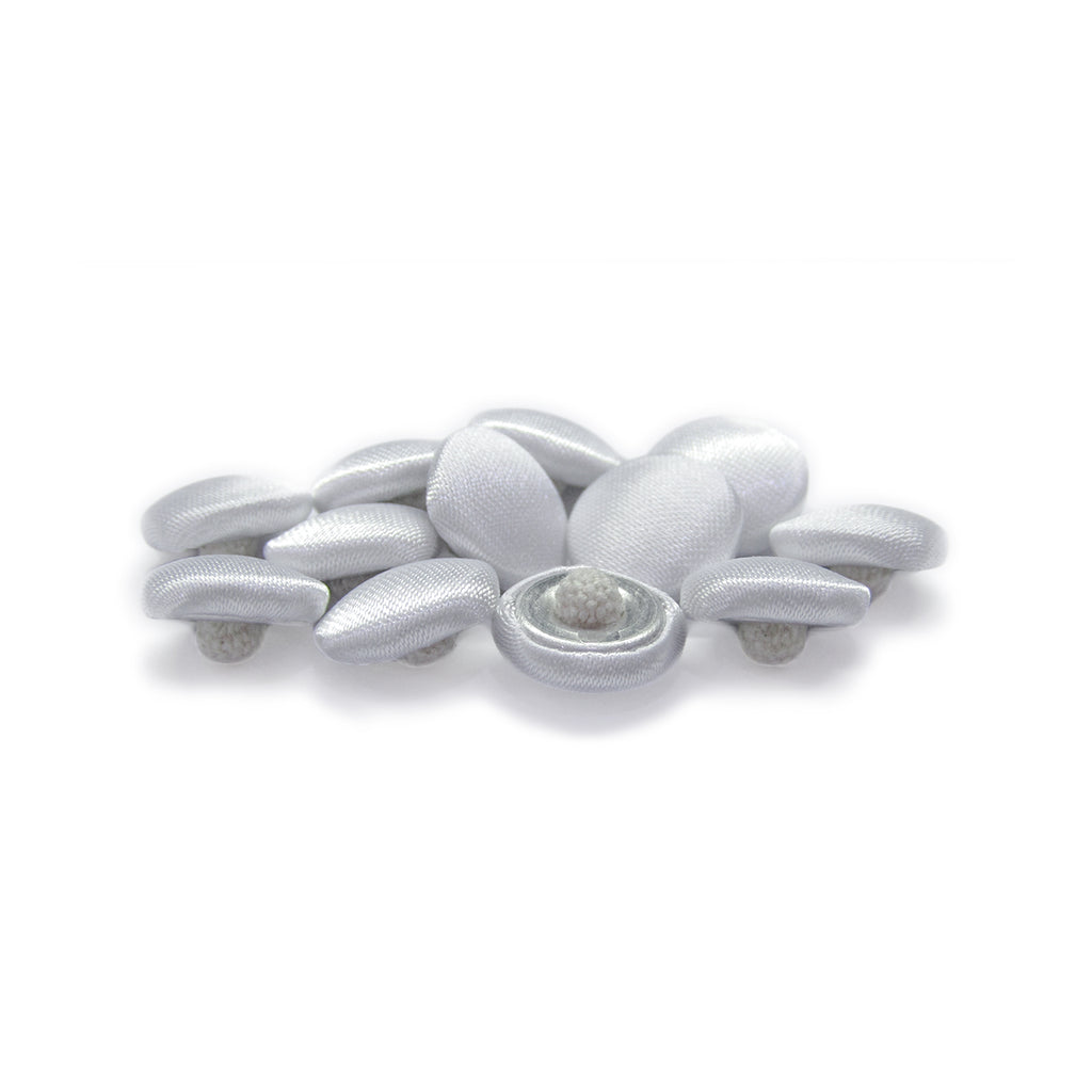 Silk Satin Bridal Buttons: a collection of smooth, oval, white buttons grouped on a white background, ideal as delicate trim for wedding dresses.