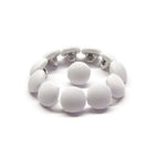 A Taffeta Bridal Buttons bracelet, crafted from delicate white buttons, is elegantly displayed in a circular arrangement on a white background.