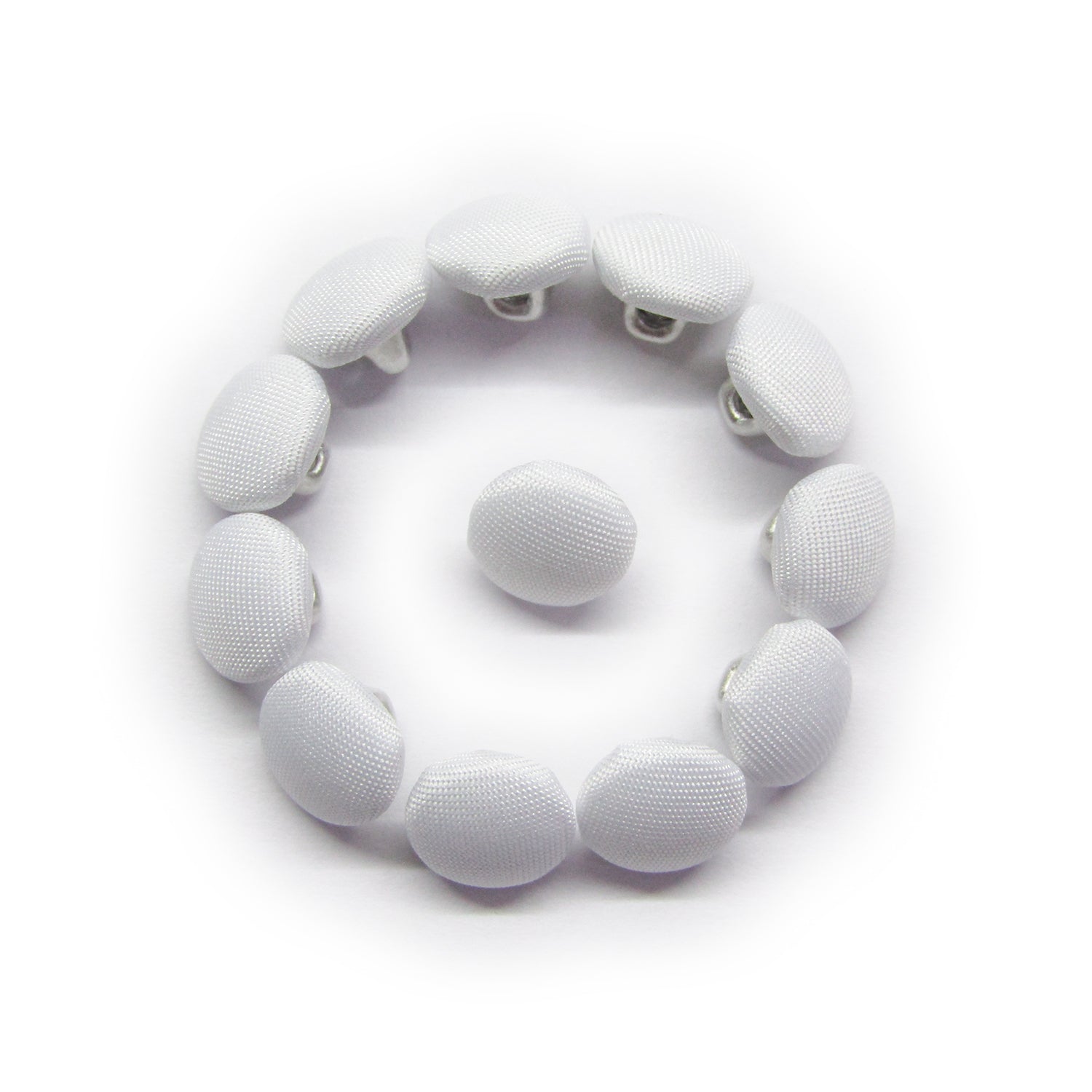 Twelve Taffeta Bridal Buttons in white are arranged in a circle around a central button, creating a smiley face design.