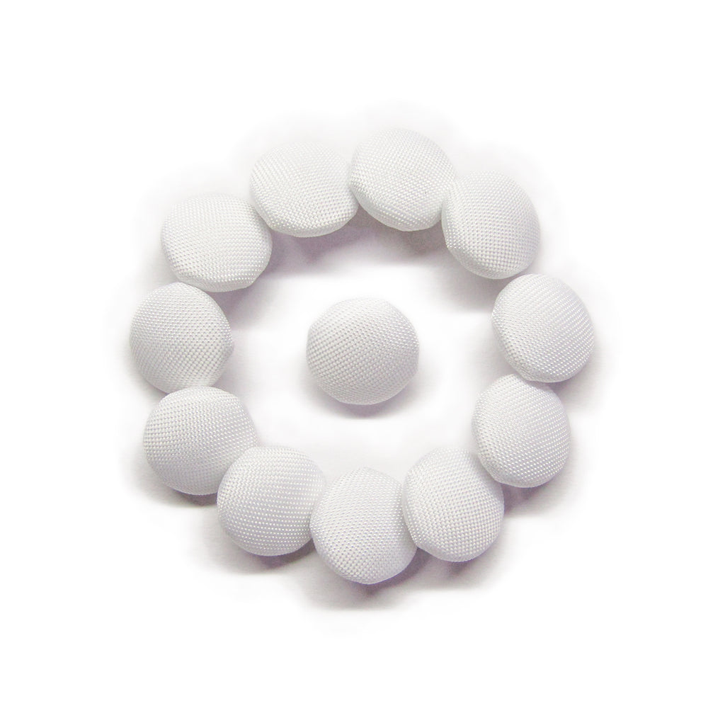 Eleven Taffeta Bridal Buttons are arranged in a circle around one on a white background, evoking the elegant details of a wedding dress.