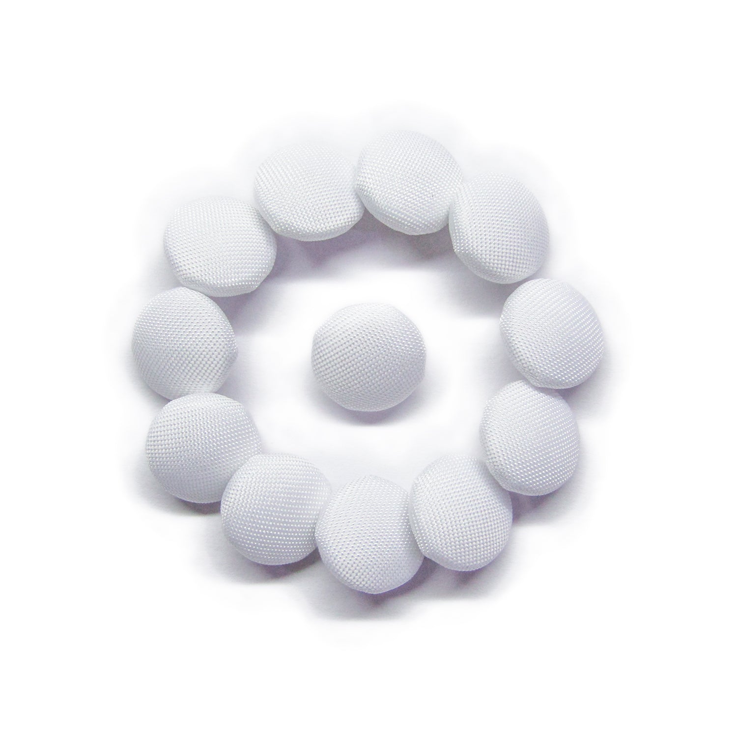 Eleven Taffeta Bridal Buttons, in crisp white and circular like mesh pads, are arranged in a ring with one button placed at the center.