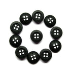 Twelve scratchproof black Rubber Shirt Buttons with four holes, arranged in a circle on a white background—ideal for children's clothing.