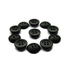 Ten black Rubber Shirt Buttons, each scratchproof with four holes, are arranged in a neat circle on a white background—perfect for children's clothing.