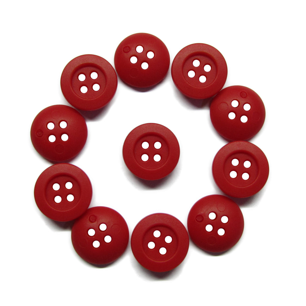 Eleven red Rubber Shirt Buttons, each scratchproof with four holes, are arranged in a circle on a white surface—ideal for children's clothing.