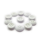 Ten round, white Rubber Shirt Buttons with four holes and scratchproof surfaces are arranged in a neat circle on a white background—ideal for children’s clothing.