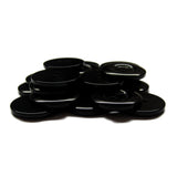 A pile of Commercial Food Service Buttons, black and round on a white background—ideal replacements for work uniform buttons.