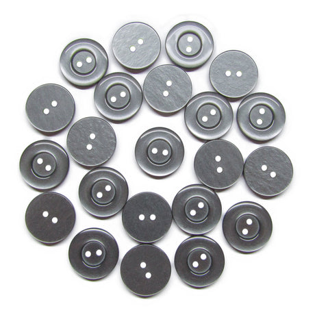 Twenty-five Commercial Food Service Buttons, round and gray with two holes, are arranged in a loose circular pattern on a white background.