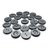 A set of round black and gray Commercial Food Service Buttons, each with two holes, displayed on a white background.