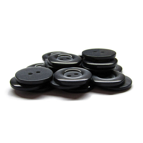 A pile of black, round Commercial Food Service Buttons with two holes each—perfect as plain uniform buttons—set against a white background.