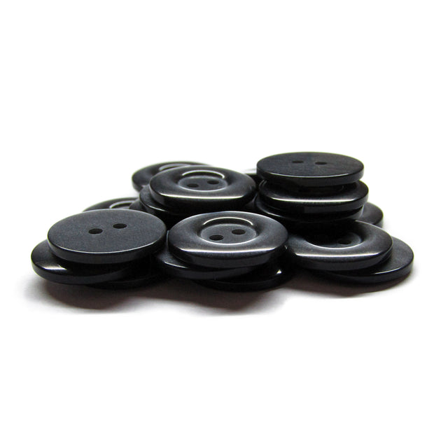 A pile of black, round Commercial Food Service Buttons with two holes each—perfect as plain uniform buttons—set against a white background.