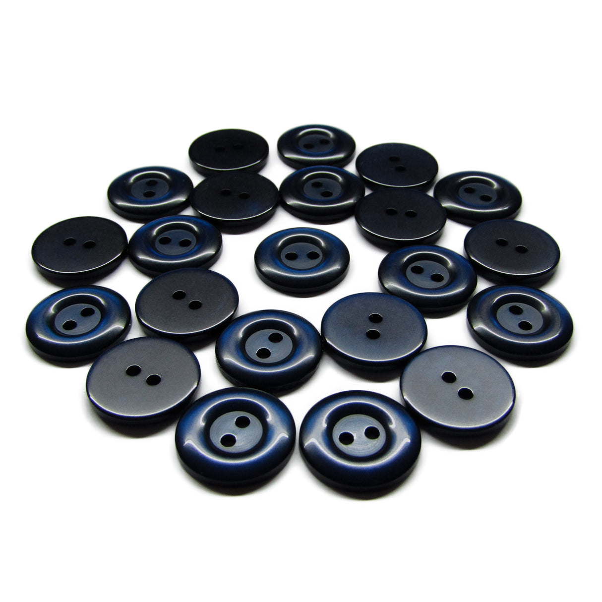 A collection of dark blue and black round Commercial Food Service Buttons with two holes, scattered on a white surface.