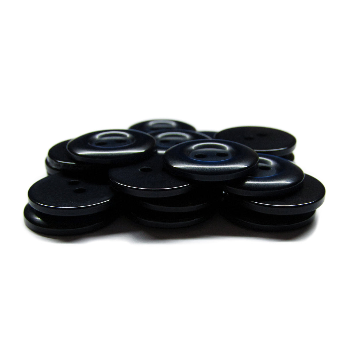 A stack of round, black Commercial Food Service Buttons with four holes each on a white background—perfect as plain uniform buttons for any work attire.
