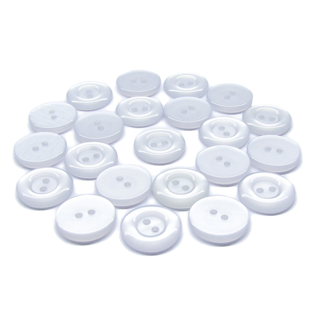 Several Commercial Food Service Buttons, white, round, and featuring two holes, are scattered on a plain white background.