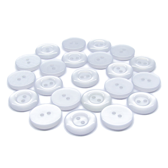 Several Commercial Food Service Buttons, white, round, and featuring two holes, are scattered on a plain white background.