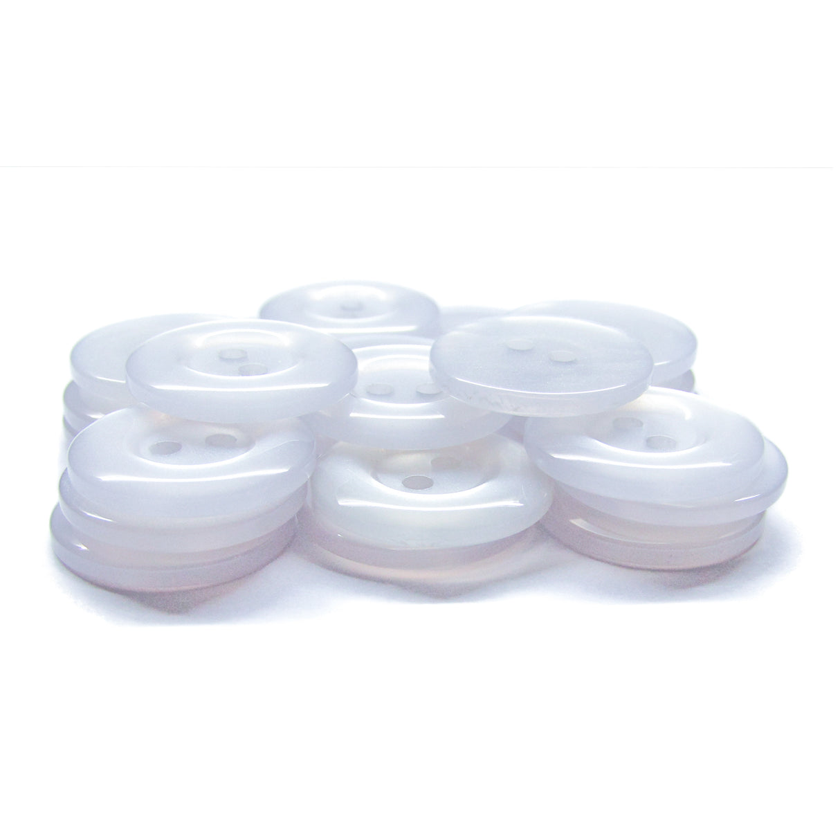 A stack of translucent white Commercial Food Service Buttons with two holes is displayed on a white surface, offering a modern alternative to the classic black nylon buttons typically found on work uniforms.